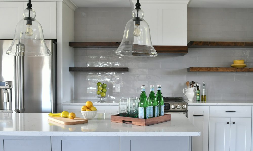 Kitchen in a new home with open concept layout, white counters cabinets floating wood shelves